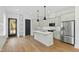 Stylish kitchen with modern pendant lights, stainless steel appliances, and a quartz countertop island at 2728 Milburnie Rd, Raleigh, NC 27610