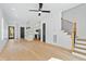 Spacious living room with open floor plan leading to the kitchen and staircase at 2728 Milburnie Rd, Raleigh, NC 27610