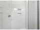 Shower with glass door and white tiled walls featuring a built in storage nook at 2728 Milburnie Rd, Raleigh, NC 27610