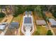 Aerial view of house with gray roof, long driveway, garages, and surrounding area at 2730 Milburnie Rd, Raleigh, NC 27610