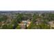 An aerial view of the property surrounded by lush trees with city skyline in the distance at 2730 Milburnie Rd, Raleigh, NC 27610