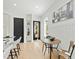 Bright breakfast nook featuring light wood floors, black door, and modern light fixture at 2730 Milburnie Rd, Raleigh, NC 27610