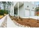 Exterior view featuring a concrete walkway, landscaped beds with rocks and mulch, and light green siding at 2730 Milburnie Rd, Raleigh, NC 27610