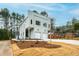 Contemporary home with a two-car garage, light green siding, landscaped front yard, and blue sky at 2730 Milburnie Rd, Raleigh, NC 27610