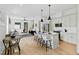 Open concept living space featuring a modern kitchen with an island and seating, flowing into a cozy living room at 2730 Milburnie Rd, Raleigh, NC 27610