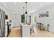 Bright and modern kitchen featuring stainless steel appliances, an island with seating, and an adjacent dining area at 2730 Milburnie Rd, Raleigh, NC 27610