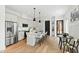 Modern kitchen with stainless steel appliances, a center island with seating, and an adjacent dining area at 2730 Milburnie Rd, Raleigh, NC 27610