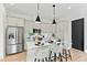 Bright kitchen featuring stainless steel appliances, an island with bar seating, and modern pendant lighting at 2730 Milburnie Rd, Raleigh, NC 27610