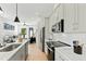 Modern kitchen seamlessly connects to the living area, featuring sleek appliances and stylish finishes at 2730 Milburnie Rd, Raleigh, NC 27610