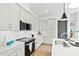 Modern kitchen with white cabinets, stainless steel appliances, and a center island with barstool seating at 2730 Milburnie Rd, Raleigh, NC 27610