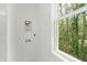 A bright laundry area with window to the backyard, tiled wall and modern electrical outlets at 2730 Milburnie Rd, Raleigh, NC 27610