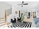 Open-concept living room with stairs, chic furniture, and views into the modern kitchen at 2730 Milburnie Rd, Raleigh, NC 27610