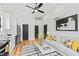 Open living area featuring a comfortable couch, abstract art, hardwood floors, and modern lighting at 2730 Milburnie Rd, Raleigh, NC 27610