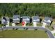 A neighborhood featuring well-maintained homes, green lawns, and mature trees lining the streets at 286 Two Creeks Lp, Chapel Hill, NC 27517