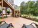 Backyard patio area with seating, landscaping, a fence and stairs leading to an upper porch at 286 Two Creeks Lp, Chapel Hill, NC 27517
