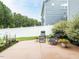 Backyard patio area with seating, landscaping, a fence and views of the blue house at 286 Two Creeks Lp, Chapel Hill, NC 27517