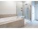 Bright bathroom showcasing a modern tiled shower with glass enclosure next to a soaking tub at 286 Two Creeks Lp, Chapel Hill, NC 27517