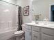 Well-lit bathroom featuring a shower-tub combo and a vanity with a white countertop at 286 Two Creeks Lp, Chapel Hill, NC 27517