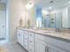 Elegant bathroom featuring a double vanity with granite countertop and a large, well-lit mirror at 286 Two Creeks Lp, Chapel Hill, NC 27517
