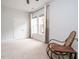 Cozy bedroom showcasing a vintage rocking chair and ample natural light from the nearby windows at 286 Two Creeks Lp, Chapel Hill, NC 27517