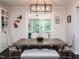 Dining room features stylish lighting fixture, a spacious table, and access to the outdoors at 286 Two Creeks Lp, Chapel Hill, NC 27517
