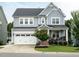 Charming two-story home with a welcoming front porch, white garage door, and landscaped yard at 286 Two Creeks Lp, Chapel Hill, NC 27517