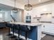 Beautiful kitchen island boasts sleek stools, granite countertops, and modern pendant lighting at 286 Two Creeks Lp, Chapel Hill, NC 27517