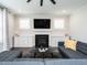 Cozy living room features a modern fireplace, built-in cabinets, and a comfortable gray sectional sofa at 286 Two Creeks Lp, Chapel Hill, NC 27517