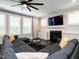 Comfortable living room with a fireplace, large sectional sofa, and plenty of natural light at 286 Two Creeks Lp, Chapel Hill, NC 27517