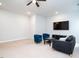 Bright living room features neutral carpet, ceiling fan, and comfortable seating arrangement at 286 Two Creeks Lp, Chapel Hill, NC 27517
