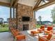 Relaxing outdoor area with a stone fireplace, comfortable seating, and views of the community at 286 Two Creeks Lp, Chapel Hill, NC 27517
