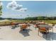 Scenic outdoor patio featuring tables and chairs overlooking the golf course and landscape at 286 Two Creeks Lp, Chapel Hill, NC 27517