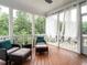 Relaxing screened-in porch with comfortable seating and views of the surrounding trees at 286 Two Creeks Lp, Chapel Hill, NC 27517