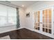 Versatile room with french doors, hardwood floors and a large window at 286 Two Creeks Lp, Chapel Hill, NC 27517