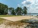 Community volleyball court with scenic views of lake at 286 Two Creeks Lp, Chapel Hill, NC 27517