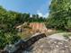 Scenic waterfall cascading into a pond with lush greenery and a stone bridge at 286 Two Creeks Lp, Chapel Hill, NC 27517