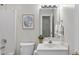Bathroom with white vanity, toilet and mirror at 2905 Whitehart Ln, Raleigh, NC 27606