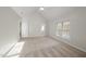 Spacious bedroom with high ceiling, carpet, and a view into a hallway and bathroom at 2905 Whitehart Ln, Raleigh, NC 27606