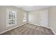 Carpeted bedroom with two windows and neutral walls at 2905 Whitehart Ln, Raleigh, NC 27606