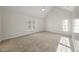 Spacious bedroom featuring vaulted ceilings, soft carpet, and bright double windows at 2905 Whitehart Ln, Raleigh, NC 27606