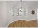 Charming dining area with bay window, contemporary chandelier, and warm wood flooring at 2905 Whitehart Ln, Raleigh, NC 27606