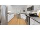 Spacious kitchen with stainless steel appliances, white cabinets, and black countertops at 2905 Whitehart Ln, Raleigh, NC 27606