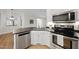 Bright kitchen featuring stainless steel appliances, white cabinetry, and a stylish corner layout at 2905 Whitehart Ln, Raleigh, NC 27606