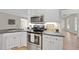 Cozy kitchen with stainless steel appliances, white cabinets, and sleek black countertops at 2905 Whitehart Ln, Raleigh, NC 27606