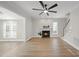 Bright living room featuring a fireplace, ceiling fan, hardwood floors and stairway to upper level at 2905 Whitehart Ln, Raleigh, NC 27606