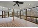 Spacious screened porch with wood flooring, ceiling fans, and outdoor views at 2905 Whitehart Ln, Raleigh, NC 27606