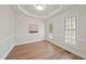 Sunlit room with wood floors, white trim, chair rail, and neutral paint at 2905 Whitehart Ln, Raleigh, NC 27606