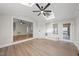 Open sunroom featuring a ceiling fan, skylight, and access to a side door and the living room at 2905 Whitehart Ln, Raleigh, NC 27606