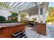 Picturesque backyard features a hot tub, an outdoor dining area, and landscaping, ideal for entertaining and relaxation at 303 Laurel Hill Road, Chapel Hill, NC 27514