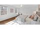 Bright bedroom featuring hardwood floors and white walls with many windows that let in natural light at 303 Laurel Hill Road, Chapel Hill, NC 27514